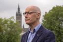 First Minister John Swinney campaigning in Glasgow in September