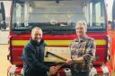 Llanfyllin Firefighter John Kevin Williams being presented with a retirement plaque.