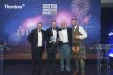 Bob and Robert collecting their award at the ceremony in Glasgow with host Cammy Wilson