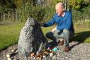 Paul Paris beside a memorial to Janet Horne in Dornoch