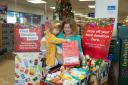 Jess McCulloch with her daughter donating food to the campaign