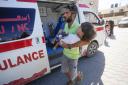 Injured Palestinians, including children, are brought to Al-Aqsa Martyrs Hospital in the aftermath of an Israeli attack on Nuseirat Refugee Camp on October 19, 2024