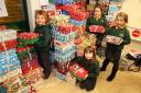 (L) Charlie Clark, Martha Anderson, Matilda Anderson and Charlotte Henderson, pupils from Whitley Chapel First School, took their boxes to Operation Christmas Child HQ in Hexham in 2014