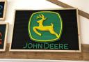 A John Deere emblem is among the items to be auctioned off for charity