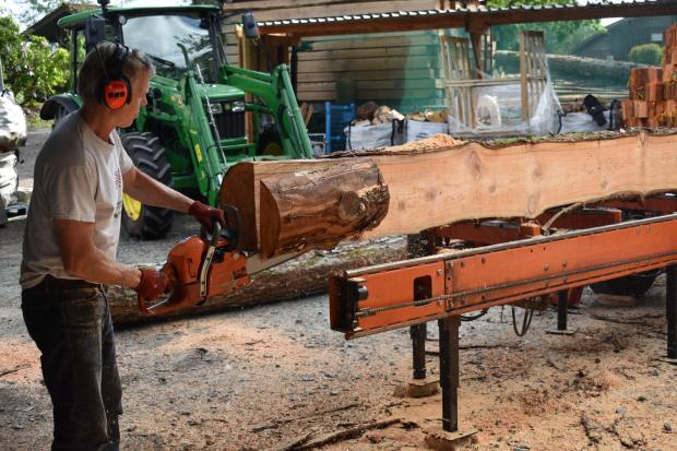 Forestry Journal: Alasdair cuts a piece from the end of the 7.4 m log to get a clean, straight edge all the way along.