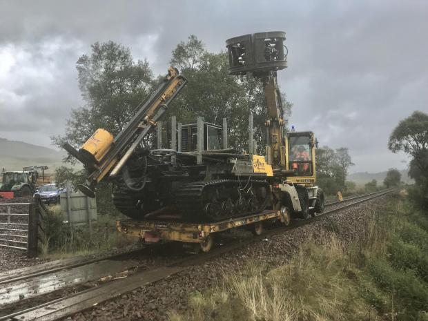 Forestry Journal:  At South of Falls of Falloch above Loch Lomond, and to allow access to be gained, a tracked post chipper on a road railer being taken down the track of one and a half miles to landslip which had taken out 300 metres of fencing.
