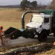 Xander feeding the chipper for a job, for Savills, on Muckrach Estate, Dulnain Bridge.