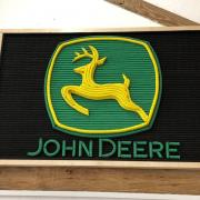 A John Deere emblem is among the items to be auctioned off for charity