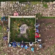 People gather around the stump of the Sycamore Gap tree in Northumberland National Park. The 